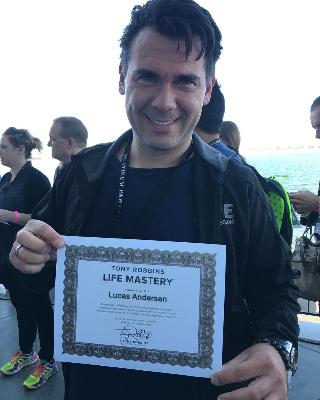 Lucas Andersen holding a Life Mastery certificate